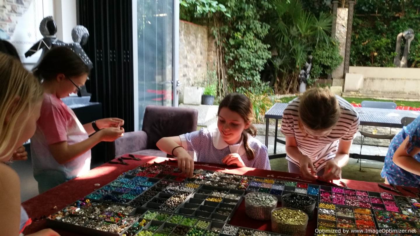 9, 10 and 11 year old girls choosing beads and charms for jewellery projects