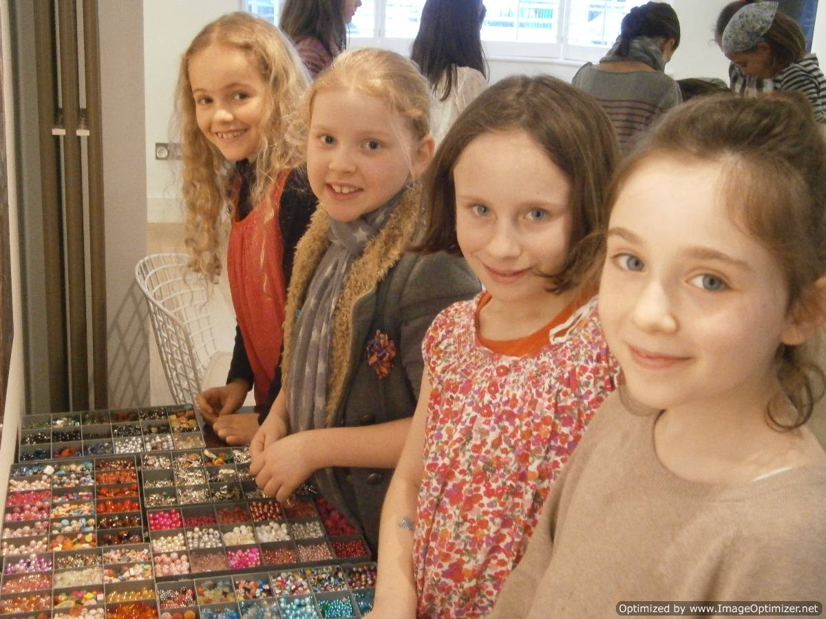 happy 7 year old girls making jewellery