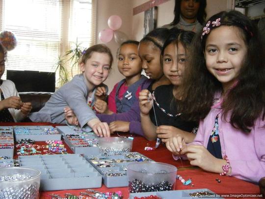 happy girls choosing beads during jewellery making party
