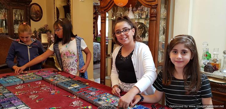 Happy girl's faces while choosing beads and charms to make jewellery